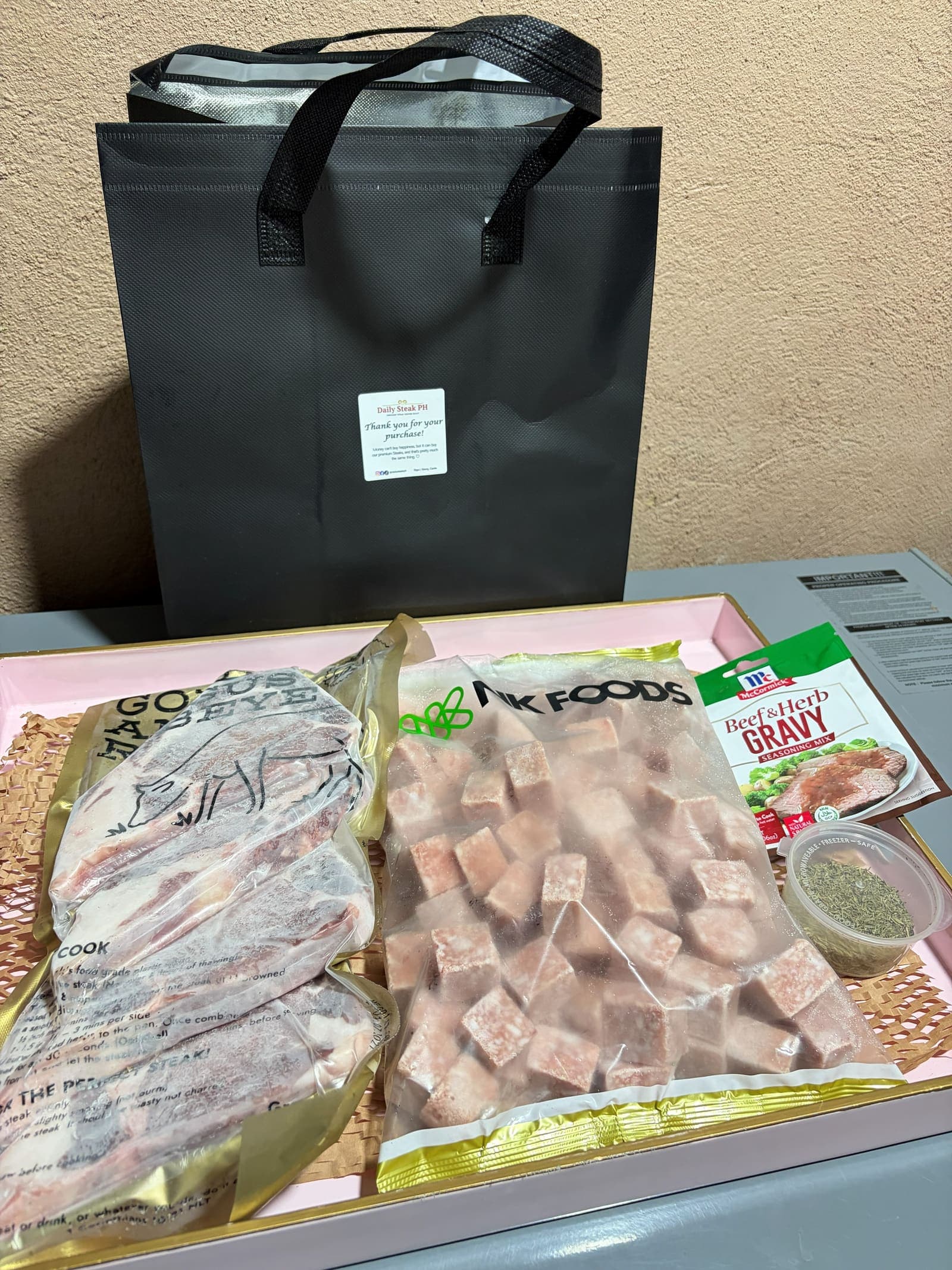 A complete Daily Steak PH order boxed up: gold ribeye, NK Foods wagyu cubes, beef and herb gravy mix and thyme leaves