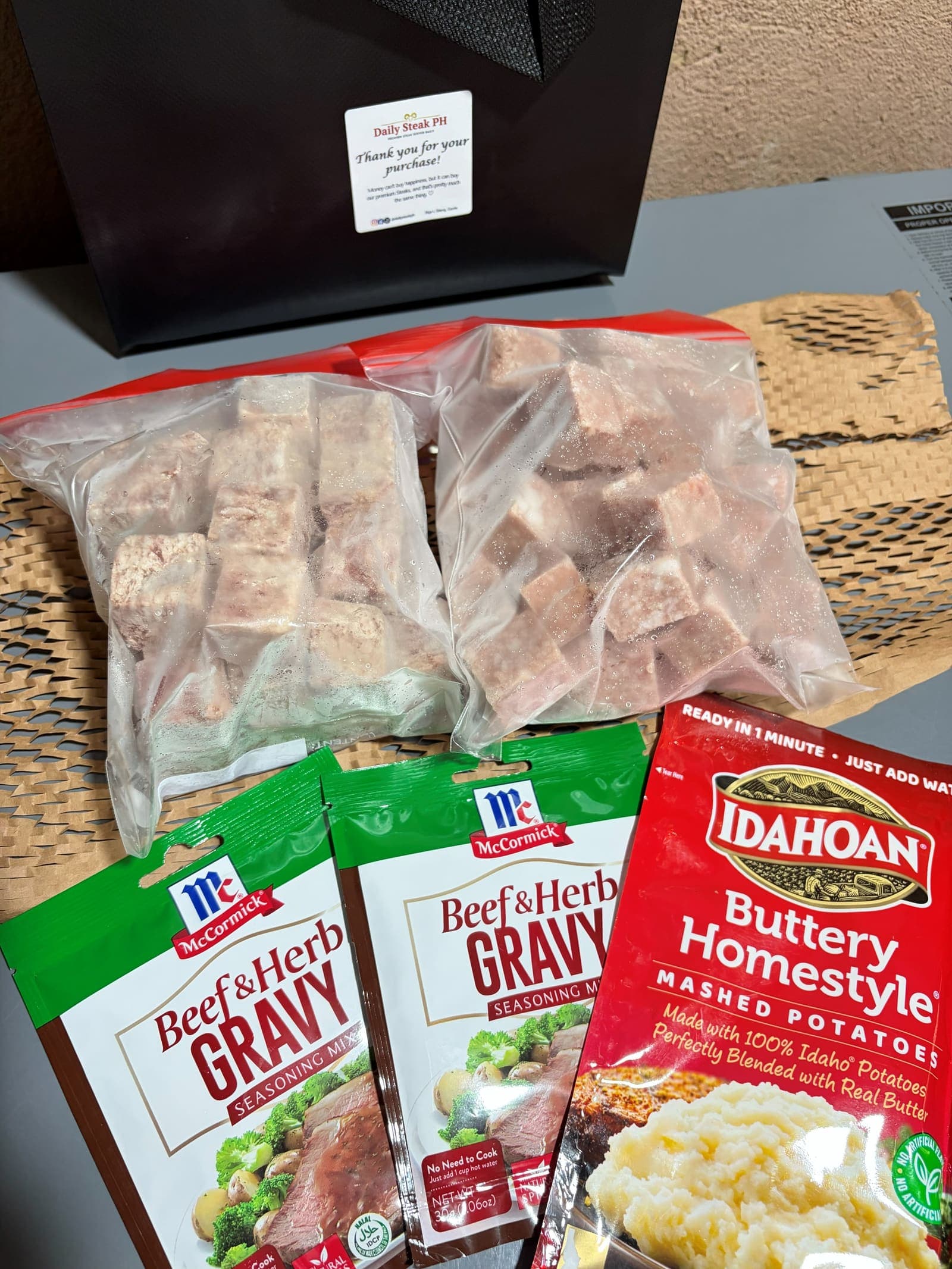 Two packs of wagyu cubes with beef and herb gravy and Idahoan buttery homestyle mashed potatoes